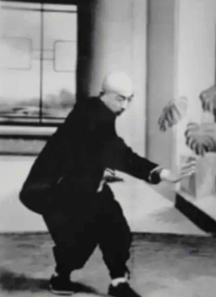 Historical Xingyiquan master demonstrating a low forward-folding posture and whole-body structure
