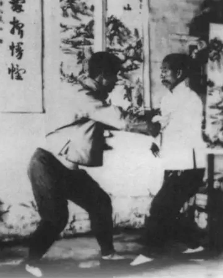 Sun Lutang and Sun Cunzhou demonstrating push hands with forward inclination and central balance